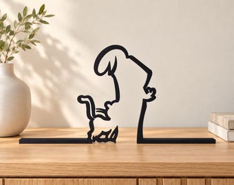 May include: A black metal bookend set featuring a continuous line art design of a cat standing on its hind legs and reaching upward. The two-piece set is constructed from thin, flat metal strips that form the silhouette of a feline figure.