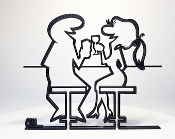 May include: Black metal sculpture depicting a couple at a table, with minimalist line art style. The figures are seated, with one holding a glass. The sculpture is on a white background.