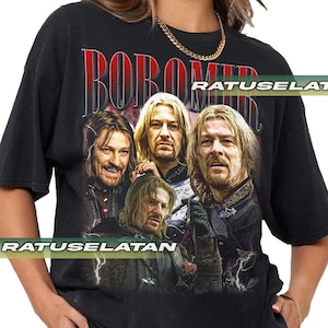 May include: Black t-shirt featuring a graphic of Boromir from The Lord of the Rings. The word "BOROMIR" is printed in red at the top. The image shows four different portraits of the character. The shirt is a vintage style.