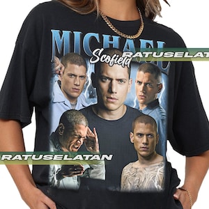 May include: Black t-shirt with a graphic print of Michael Scofield from the TV show Prison Break. The graphic features multiple images of Scofield in different poses, with the text "Michael Scofield" printed above the images.