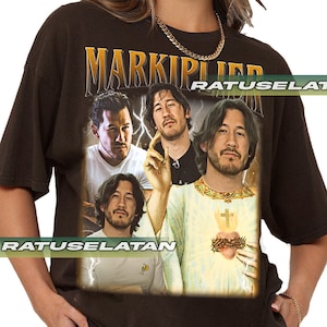 a woman wearing a black shirt with a picture of two men on it