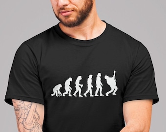 May include: Black t-shirt featuring a white graphic of the evolution of man, culminating in a man playing a guitar.