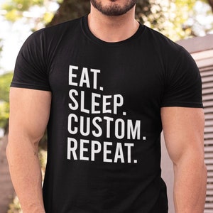 May include: Black t-shirt with white text that reads "Eat. Sleep. Custom. Repeat."