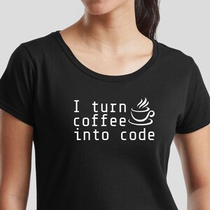 May include: Black scoop neck t-shirt with the white text "I turn coffee into code" and a coffee cup graphic. The shirt is made of a soft material and is suitable for casual wear.
