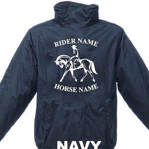 May include: A navy blue jacket featuring a high collar and long sleeves. The front displays a white graphic of a person riding a horse, with the text RIDER NAME above the graphic and HORSE NAME below it. The word NAVY is printed at the bottom.