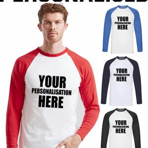 May include: A white baseball-style long-sleeved shirt with red sleeves. The text "YOUR PERSONALISATION HERE" is printed in black on the front. Additional shirts with blue, navy, and black sleeves are also shown.