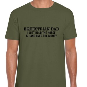 May include: A green t-shirt with the text "Equestrian Dad I just hold the horse & hand over the money" printed in black.
