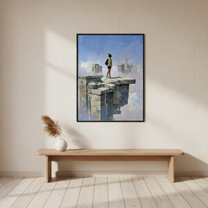 Puede incluir: Una impresión artística enmarcada representa a una persona de pie sobre una estructura de piedra, mirando una ciudad en las nubes. La obra de arte utiliza azules, grises y amarillos, con un marco negro. La impresión se exhibe sobre un banco de madera.