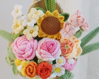May include: A handcrafted crochet floral arrangement in a woven basket. The bouquet features a sunflower, pink roses, orange and yellow blossoms, and green leaves. The text "Small - 2" is visible.