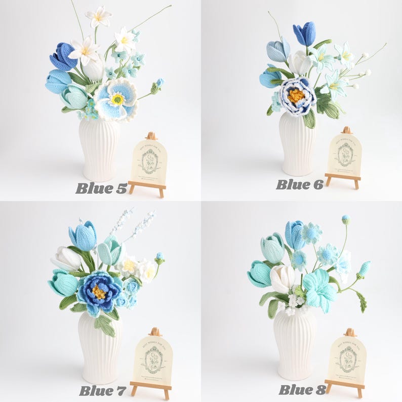 May include: Four arrangements of crocheted flowers in white ribbed vases, labeled Blue 5, Blue 6, Blue 7, and Blue 8. Each bouquet features various shades of blue, white, and green yarn petals, leaves, and stems, displayed with small wooden easels.