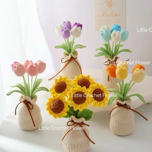 May include: A selection of handmade crochet flowers in small beige vases. The flowers include tulips in various colours, and sunflowers. The text "Little Crochet Flower" is visible on some vases. A sign that says "Tulips" is in the background.