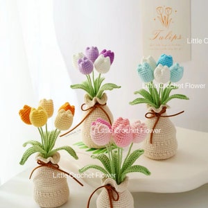 May include: Handmade crochet tulip flowers in small beige vases, tied with brown string. The tulips are in shades of yellow, orange, pink, purple, and blue. The text "Little Crochet Flower" is visible.