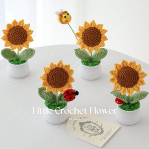 May include: Crocheted sunflowers in white pots with green leaves and brown centers. A crocheted bee and ladybugs accent the flowers. The text "Little Crochet Flower" is visible.