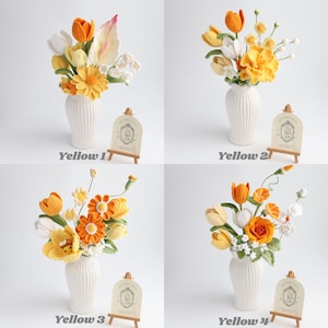 May include: Four arrangements of crocheted flowers in white ribbed vases, labeled Yellow 1 through Yellow 4. Each bouquet features various yellow, orange, and white yarn-crafted blossoms, including tulips, daisies, and roses, with green stems.