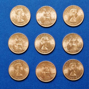 Könnte beinhalten: Neun Kupfermünzen mit der Aufschrift "One Penny" und dem Porträt von Königin Elisabeth II. Die Münzen sind mit 1967 datiert.