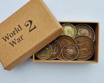 May include: A small rectangular brown cardboard box with the text World War 2 printed on the lid. Inside the box are several vintage British coins, including pennies and a farthing, featuring various designs like a bird and a seated figure.
