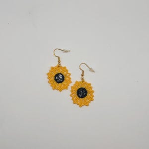 Yellow sunflower lace earrings crafted with vibrant embroidery thread to make a stunning addition to any outfit, adding a feminine and delicate touch. These earrings are super lightweight, unique, and make a wonderful gift for any occasion. The hypoallergenic French ear wire hooks and jump rings are made from stainless steel and include clear silicone earring backs. Measurements: Refer to Size / Select an option