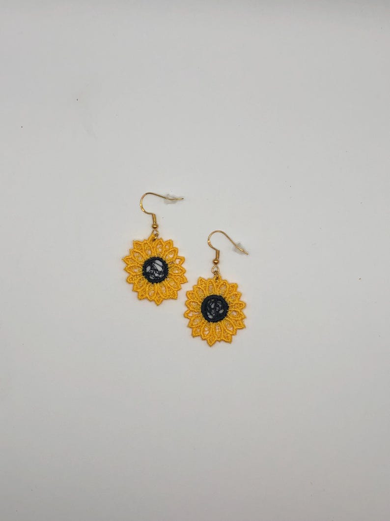 Yellow sunflower lace earrings crafted with vibrant embroidery thread to make a stunning addition to any outfit, adding a feminine and delicate touch. These earrings are super lightweight, unique, and make a wonderful gift for any occasion. The hypoallergenic French ear wire hooks and jump rings are made from stainless steel and include clear silicone earring backs. Measurements: Refer to Size / Select an option