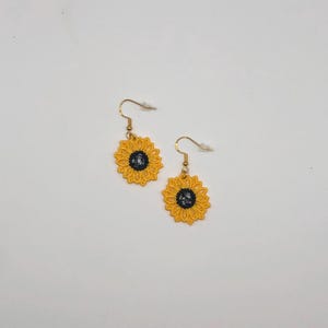 Yellow sunflower lace earrings crafted with vibrant embroidery thread to make a stunning addition to any outfit, adding a feminine and delicate touch. These earrings are super lightweight, unique, and make a wonderful gift for any occasion. The hypoallergenic French ear wire hooks and jump rings are made from stainless steel and include clear silicone earring backs. Measurements: Refer to Size / Select an option