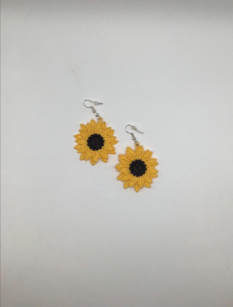Yellow sunflower lace earrings crafted with vibrant embroidery thread to make a stunning addition to any outfit, adding a feminine and delicate touch. These earrings are super lightweight, unique, and make a wonderful gift for any occasion. The hypoallergenic French ear wire hooks and jump rings are made from stainless steel and include clear silicone earring backs. Measurements: Refer to Size / Select an option