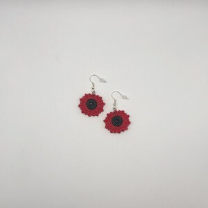 Red sunflower lace earrings crafted with vibrant embroidery thread to make a stunning addition to any outfit, adding a feminine and delicate touch. These earrings are super lightweight, unique, and make a wonderful gift for any occasion. The hypoallergenic French ear wire hooks and jump rings are made from stainless steel and include clear silicone earring backs. Measurements: Refer to Size / Select an option