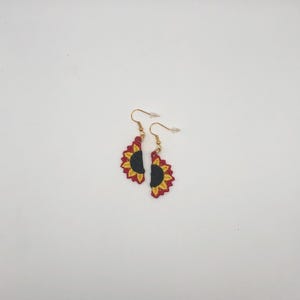 Red sunflower halves lace earrings crafted with vibrant embroidery thread to make a stunning addition to any outfit, adding a feminine and delicate touch. These earrings are super lightweight, unique, and make a wonderful gift for any occasion. The hypoallergenic French ear wire hooks and jump rings are made from stainless steel and include clear silicone earring backs. Measurements: Refer to Size / Select an option