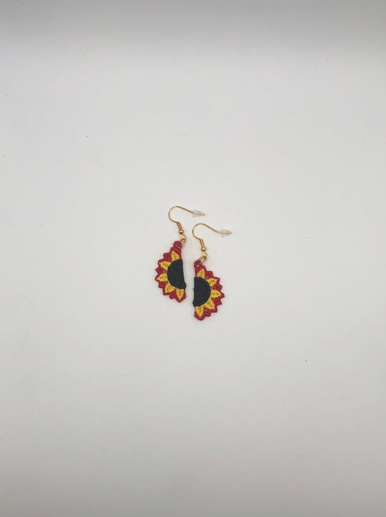 Red sunflower halves lace earrings crafted with vibrant embroidery thread to make a stunning addition to any outfit, adding a feminine and delicate touch. These earrings are super lightweight, unique, and make a wonderful gift for any occasion. The hypoallergenic French ear wire hooks and jump rings are made from stainless steel and include clear silicone earring backs. Measurements: Refer to Size / Select an option
