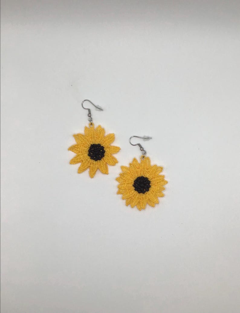 Yellow sunflower lace earrings crafted with vibrant embroidery thread to make a stunning addition to any outfit, adding a feminine and delicate touch. These earrings are super lightweight, unique, and make a wonderful gift for any occasion. The hypoallergenic French ear wire hooks and jump rings are made from stainless steel and include clear silicone earring backs. Measurements: Refer to Size / Select an option