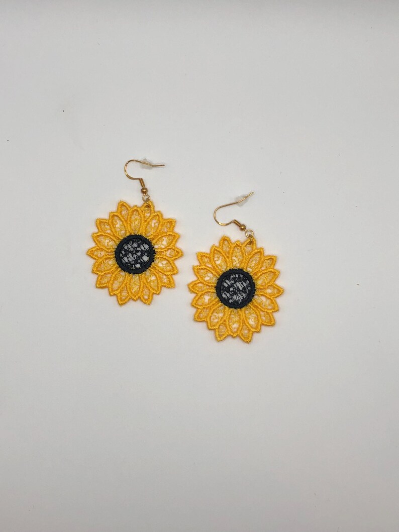 Yellow sunflower lace earrings crafted with vibrant embroidery thread to make a stunning addition to any outfit, adding a feminine and delicate touch. These earrings are super lightweight, unique, and make a wonderful gift for any occasion. The hypoallergenic French ear wire hooks and jump rings are made from stainless steel and include clear silicone earring backs. Measurements: Refer to Size / Select an option