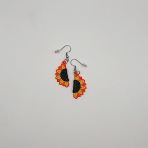 Yellow sunflower halves lace earrings crafted with vibrant embroidery thread to make a stunning addition to any outfit, adding a feminine and delicate touch. These earrings are super lightweight, unique, and make a wonderful gift for any occasion. The hypoallergenic French ear wire hooks and jump rings are made from stainless steel and include clear silicone earring backs. Measurements: Refer to Size / Select an option
