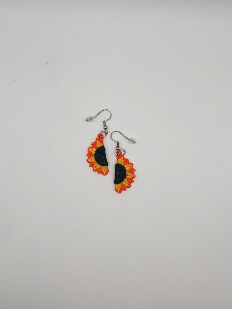 Yellow sunflower halves lace earrings crafted with vibrant embroidery thread to make a stunning addition to any outfit, adding a feminine and delicate touch. These earrings are super lightweight, unique, and make a wonderful gift for any occasion. The hypoallergenic French ear wire hooks and jump rings are made from stainless steel and include clear silicone earring backs. Measurements: Refer to Size / Select an option