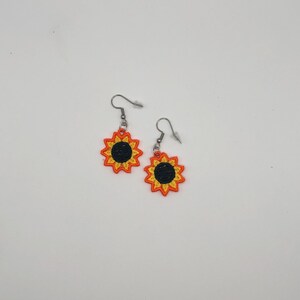 Yellow sunflower lace earrings crafted with vibrant embroidery thread to make a stunning addition to any outfit, adding a feminine and delicate touch. These earrings are super lightweight, unique, and make a wonderful gift for any occasion. The hypoallergenic French ear wire hooks and jump rings are made from stainless steel and include clear silicone earring backs. Measurements: Refer to Size / Select an option