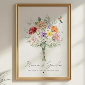 May include: A framed print with a watercolour illustration of a colourful flower bouquet. The text "Nonna's Garden" is written in script, with names below. A hummingbird is also depicted. The frame is gold-coloured.