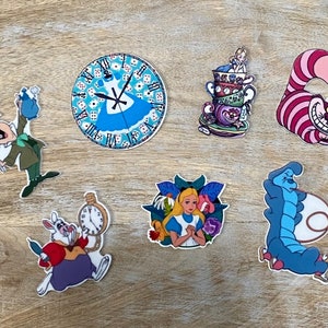 May include: A set of nine Alice in Wonderland themed stickers featuring characters such as the Mad Hatter, the Cheshire Cat, and the Queen of Hearts. The stickers are colourful and feature a variety of designs.