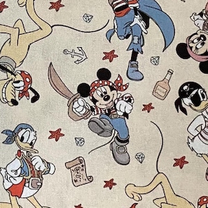 May include: A beige fabric with a repeating pattern of cartoon characters. The characters include Mickey Mouse, Pluto, Goofy, and Donald Duck. The characters are dressed as pirates and are holding various pirate-themed items, such as swords, treasure chests, and maps. The fabric is perfect for crafting projects, such as quilts, pillows, and tote bags.