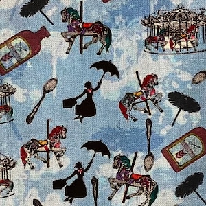 May include: A blue and white fabric with a repeating pattern of a carousel horse, a bottle of red liquid, a black umbrella, a spoon, and a black and white dustpan.