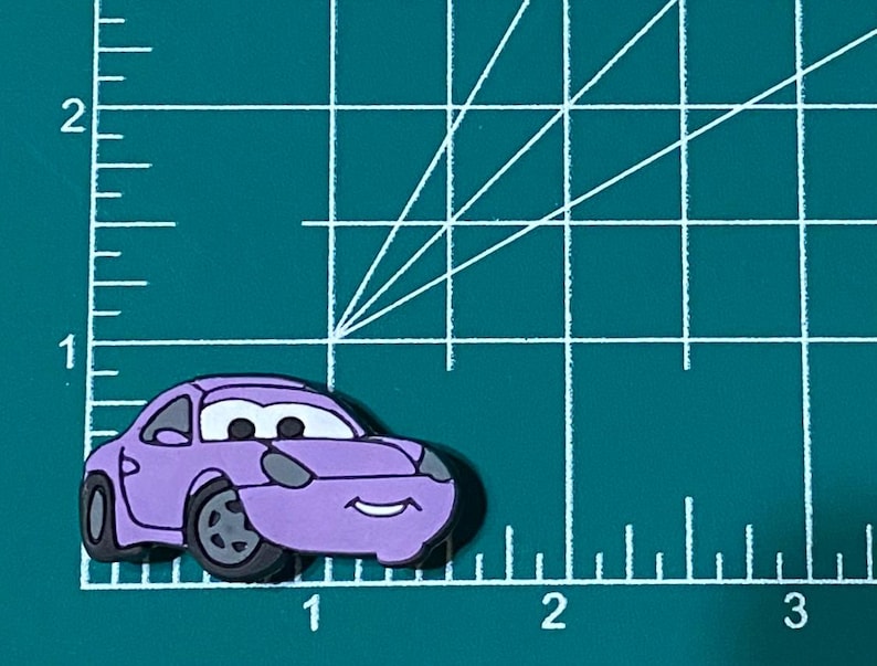 May include: A purple cartoon car with a smiling face. The car has black wheels and a black windshield.