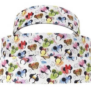 May include: Three rolls of white grosgrain ribbon featuring a colourful print of Mickey Mouse ears. The ribbon is ideal for crafting, hair bows, and other projects.