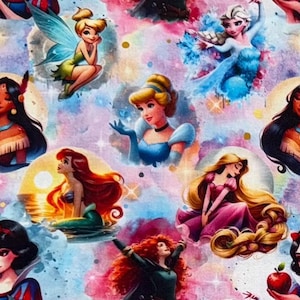 May include: A colorful fabric featuring illustrations of various Disney princesses, including Cinderella, Ariel, and Snow White. The design has a watercolor effect with a light purple and pink background, and is suitable for crafting or apparel.