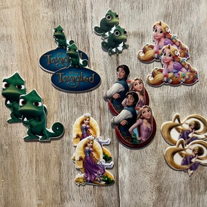 May include: A set of 10 Disney Tangled themed iron-on patches. The patches feature characters from the movie, including Rapunzel, Flynn Rider, and Pascal the chameleon. The patches are perfect for adding a touch of Disney magic to your clothing, bags, or other accessories.