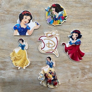 May include: Set of six Snow White themed stickers featuring various images of Snow White, the Evil Queen, and the Seven Dwarfs. The stickers are printed on white paper with a glossy finish.