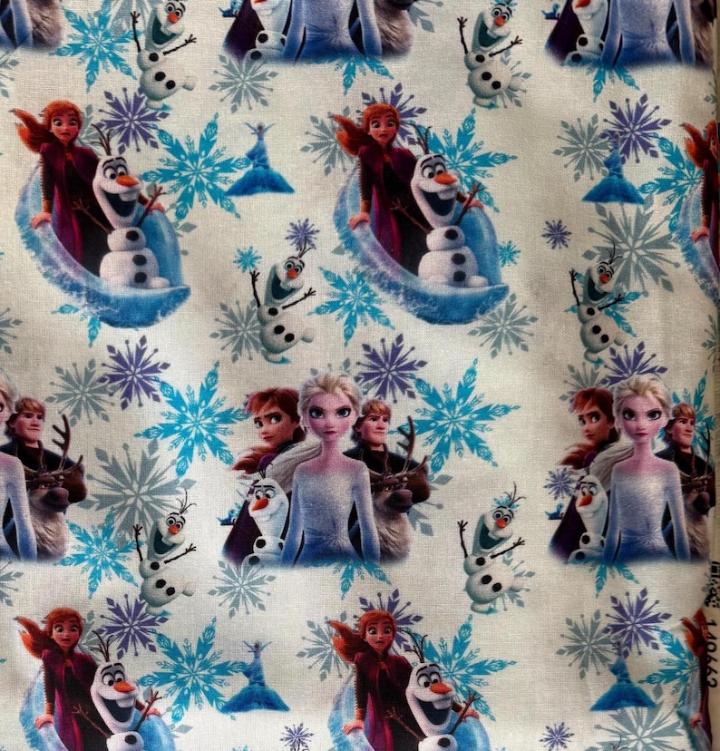 May include: White fabric featuring a repeating pattern of characters and elements from the animated film "Frozen." The design includes images of Elsa, Anna, Olaf, snowflakes, and other related imagery in shades of blue, purple, and white.