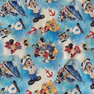 May include: Fabric with a repeating pattern featuring Mickey Mouse, Minnie Mouse, Goofy, and Donald Duck in nautical attire. The design includes anchors, boats, and a light blue watercolor background.