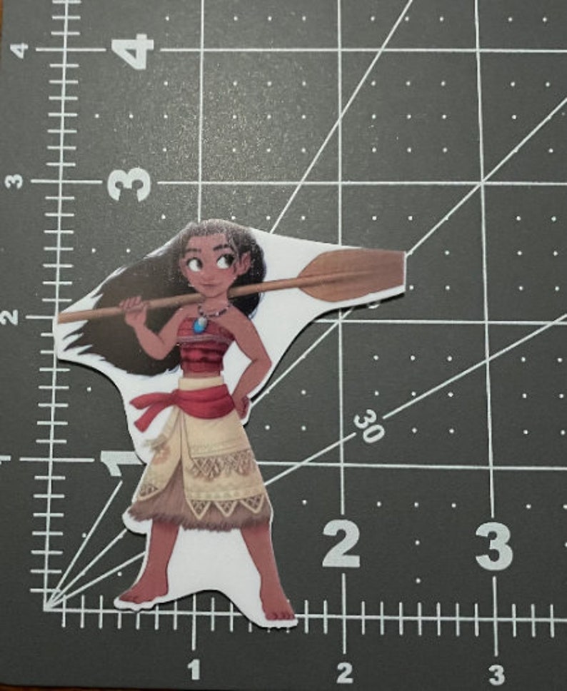 May include: A cartoon illustration of Moana from the Disney movie Moana. She is wearing a brown and red outfit with a blue necklace and holding a wooden paddle.
