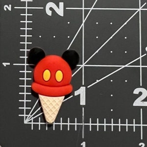 May include: Red and yellow ice cream cone with Mickey Mouse ears.