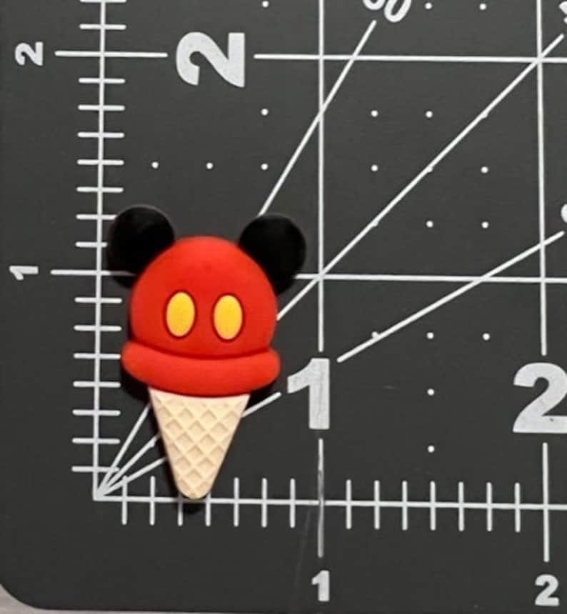 May include: Red and yellow ice cream cone with Mickey Mouse ears.