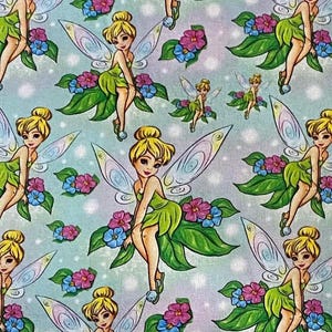 May include: A light blue fabric with a repeating pattern of fairies with iridescent wings, green dresses, and flowers. The fairies are sitting on green leaves.