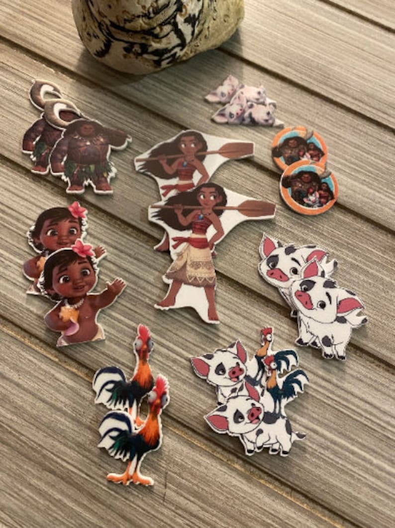 May include: A set of Moana-themed character cutouts, including Moana, Maui, Pua the pig, Hei Hei the rooster, and baby Moana. The cutouts are printed on white cardstock and are perfect for decorating a Moana-themed party.