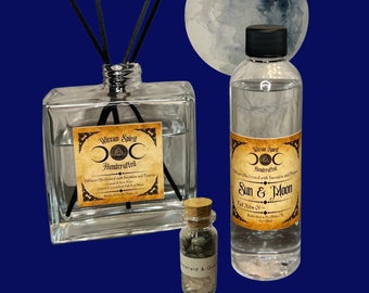 May include: A set of three glass bottles with labels that say "Witcan Spirit Handcrafted" and "Sun & Moon Full Moon Of." The bottles are filled with clear liquid and have black sticks in the larger bottle. The bottles are on a blue background with a watercolor moon.