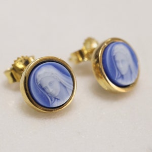 May include: A pair of gold earrings with blue and white cameo insets featuring a portrait of a woman.
